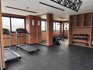 a gym with treadmills and ellipticals in a room at Modern apartment in Lima in Lima