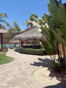 a resort with a straw umbrella and a swimming pool at Estancia Real Los Cabos in Cabo San Lucas +32 photos