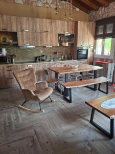 a kitchen with wooden floors and wooden tables and chairs at Villa Stella in Florina