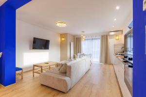 a living room with a couch and a table at La Roseraie - SPA Privé - Parking Gratuit - Jacuzzi - Familial - Professionnel in Mittelhausbergen