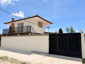 a white house with a black gate in front of it at Serenity House Antón in Coclé +19 photos