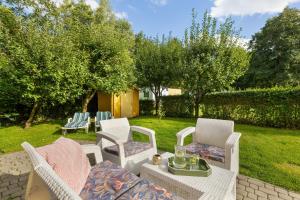 a patio with two chairs and a table with at Villa LILIA in Międzywodzie