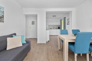 a living room with a couch and a table and chairs at Villa LILIA in Międzywodzie +39 photos