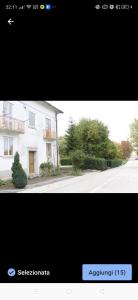 a picture of a white house and a street at La casetta del cacciatore 