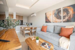 a living room with a couch and a table at Modern Stay in the Heart of Guadalajara in Guadalajara