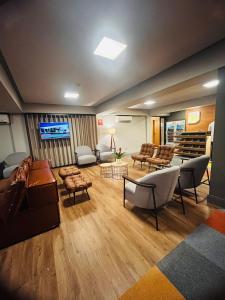 una gran sala de estar con sofás y TV de pantalla plana. en Hotel 10 Curitiba, en Curitiba