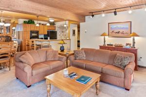 a living room with two couches and a table at Dulany 306 in Steamboat Springs