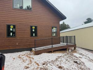 a wooden bench sitting outside of a building at 5 Bdrm 12 Guest LakeHouse with Private Boat Dock in Round Lake Seaplane Base