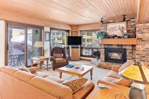 a living room with a couch and a fireplace at Dulany 306 in Steamboat Springs
