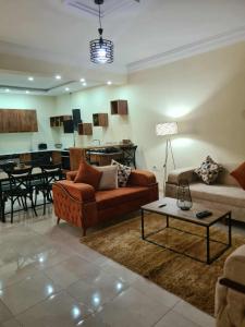 a living room with a couch and a table at Large and Luxurious 2 Bedroom Apartment in Sahline +36 photos