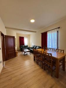 a living room with a table and a couch at Bujtina Tushaj in Lezhë