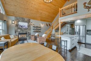 a living room with a dining room table and a kitchen at Stunning Alaskan Getaway with River and Mtn Views in Eagle River