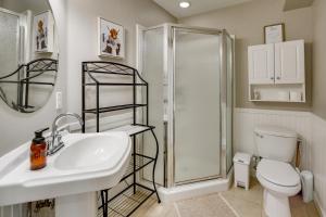 a bathroom with a sink and a shower and a toilet at Stunning Alaskan Getaway with River and Mtn Views in Eagle River +32 photos