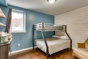 a bunk bed in a room with blue walls at Stunning Alaskan Getaway with River and Mtn Views in Eagle River