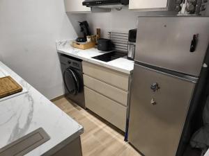 a kitchen with a refrigerator and a dishwasher at L'horizon De Coursan in Coursan +12 photos