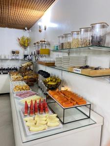 a buffet line with cheese and other food items at Max Hotel in Brasília +66 photos