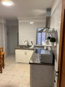 a kitchen with a sink and a counter top at Casa Sole in El Médano