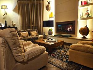a living room with a couch and a fireplace at I Lari Castel Del Monte in Castel del Monte