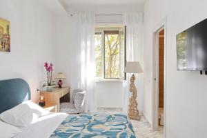 a bedroom with a bed and a desk and a window at Foro Italico Guesthouse in Rome