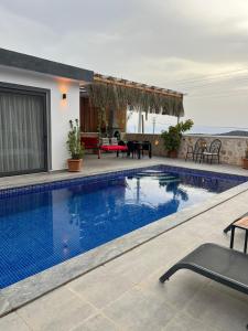 a swimming pool in front of a house at Villa karya in Kas