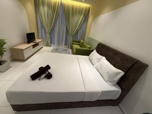 a bedroom with a bed with a cross on it at Majestic Residance Luxury Suites By klcc in Gua Sai
