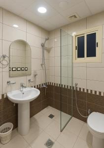 a bathroom with a sink and a shower and a toilet at فندق التاج ثلاثة مكة in Mecca +35 photos