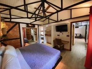 a bedroom with a bed and a flat screen tv at Buendía Lux Lotus Suite Hidden Gem Near Beach with Pool in Potrero