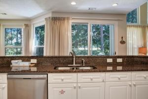 a kitchen with a sink and two windows at Turnberry 8573 in Destin