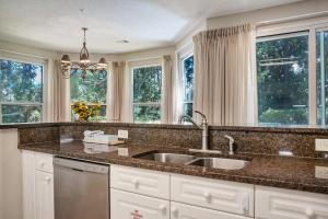 a kitchen with a sink and two windows at Turnberry 8573 in Destin