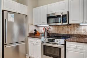 a kitchen with white cabinets and a stainless steel refrigerator at Turnberry 8573 in Destin