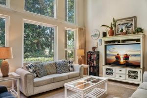 a living room with a couch and a tv at Turnberry 8573 in Destin