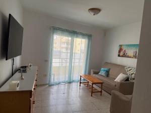a living room with a couch and a table at Casa Sole in El Médano