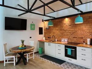 a kitchen with a table and a counter top at Buendía Lux Lotus Suite Hidden Gem Near Beach with Pool in Potrero