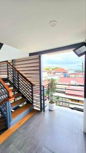 a balcony with stairs and a view of a building at Studio Units near Airport by Jade Studio Apartments in Manila
