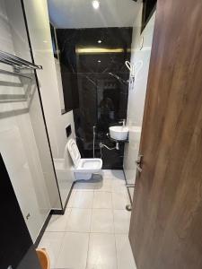 a bathroom with a toilet and a sink at The Royal palace hotel in Phalodi