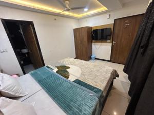 a small bedroom with a bed and a tv at The Royal palace hotel in Phalodi