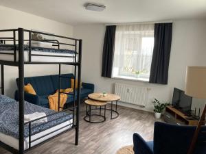 a room with two bunk beds and a table at Apartmán Lipno 1 in Lipno nad Vltavou
