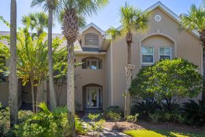 a house with palm trees in front of it at Turnberry 8561 in Destin