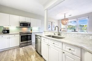 a kitchen with white cabinets and a sink at Turnberry 8561 in Destin