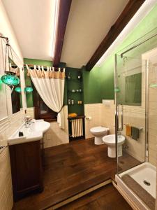 a bathroom with a sink and a toilet and a shower at I Lari Castel Del Monte in Castel del Monte +17 photos