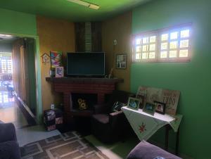 a living room with a fireplace and a flat screen tv at FICOS Hospedagem in São Gabriel +15 photos