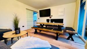 a living room with a table and a couch at T&P FamilyHaus in Bad Sooden-Allendorf