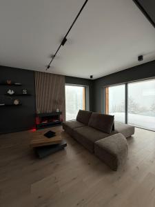 a living room with a couch and a table at Nordic Star Chalet in Fundata