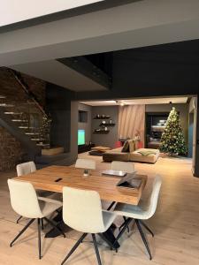 a dining room with a wooden table and a christmas tree at Nordic Star Chalet in Fundata