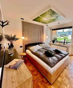 a bedroom with a large bed and a table at Ferienwohnung Harzurlaub II in Hahnenklee-Bockswiese
