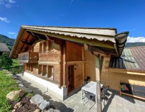 a small wooden house with a light on a patio at Ferienhaus Chalet Simeli in Grindelwald