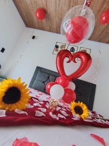a table with a heart and flowers and balloons at Finca Hotel Relax San Jerónimo in San Jerónimo +66 photos
