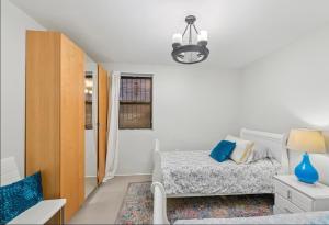 a bedroom with a bed and a chandelier at designer abode condo min to Manhattan in jersey city in Jersey City
