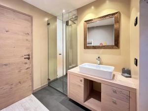 a bathroom with a sink and a shower at tabià piz meda in Moena +16 photos