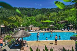 a group of people in the swimming pool at a resort at Hameau du Prat in Ribes